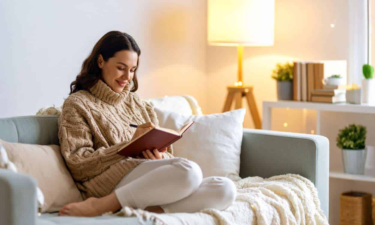 woman journaling alone in a quiet room symbolizing emotional healing and self connection through grief journaling